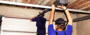 professionals in blue installing garage door opener