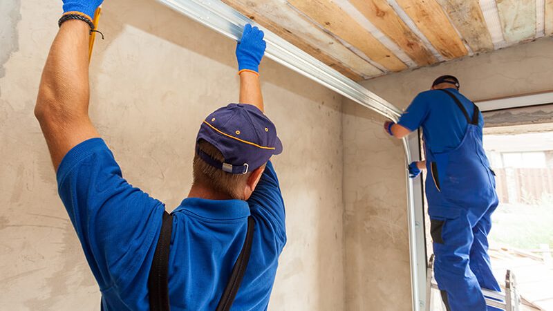 professionals performing garage door service duties